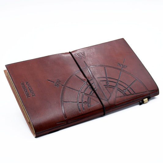 Brown handmade leather journal with embossed compass design and quote, wrap band closure.