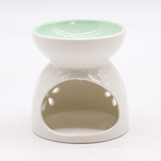 Back view of white ceramic oil burner showing tealight opening and glossy finish