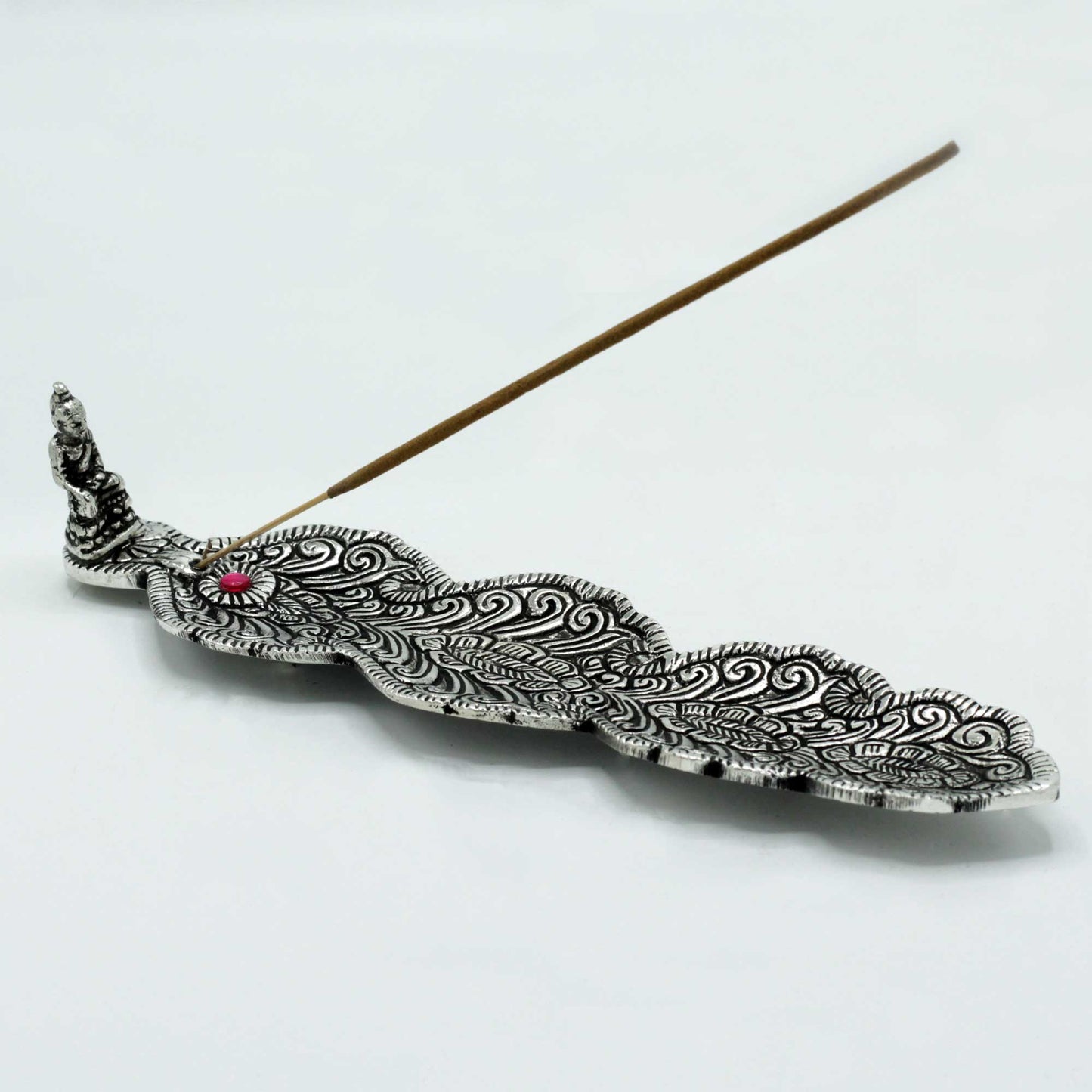 Polished aluminium feather-shaped incense holder with intricate engraving and a Buddha figure. 23cm long, ideal for stick incense and mindful décor.