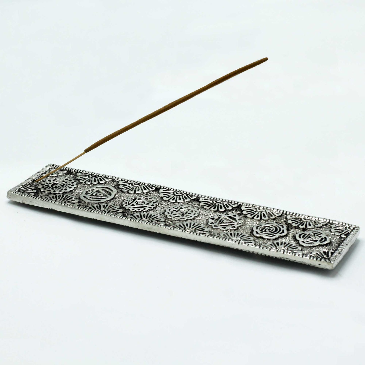 Polished aluminium incense holder with engraved chakra symbols and floral mandala patterns. 23cm long, ideal for stick incense and chakra-themed décor.