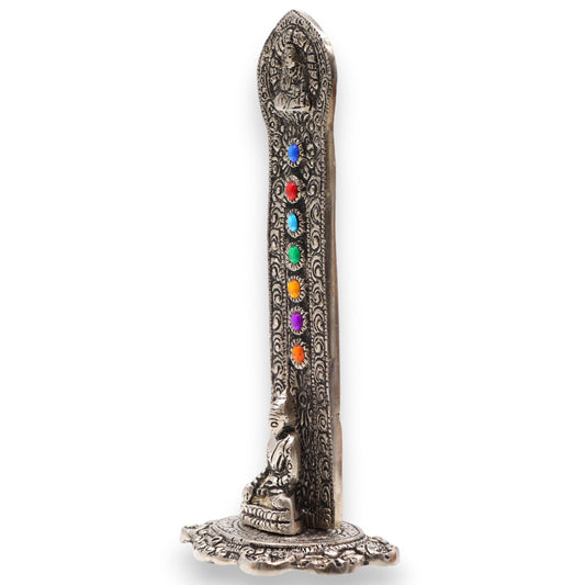 Handcrafted polished aluminium incense holder with seated Buddha and seven chakra stones. 16x6x7cm tower design ideal for meditation or altar use.