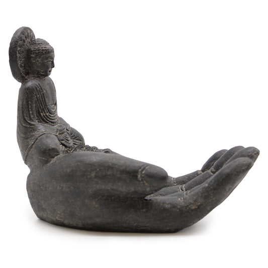 Black stone incense holder shaped like a hand with a Buddha figure, handcrafted in Indonesia