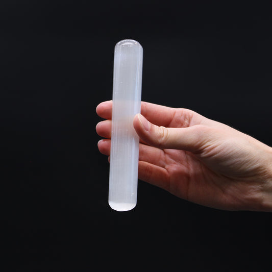 Polished Selenite wand with double rounded ends and smooth cylindrical body, hand-carved from Moroccan crystal for reiki, massage, and chakra balancing.