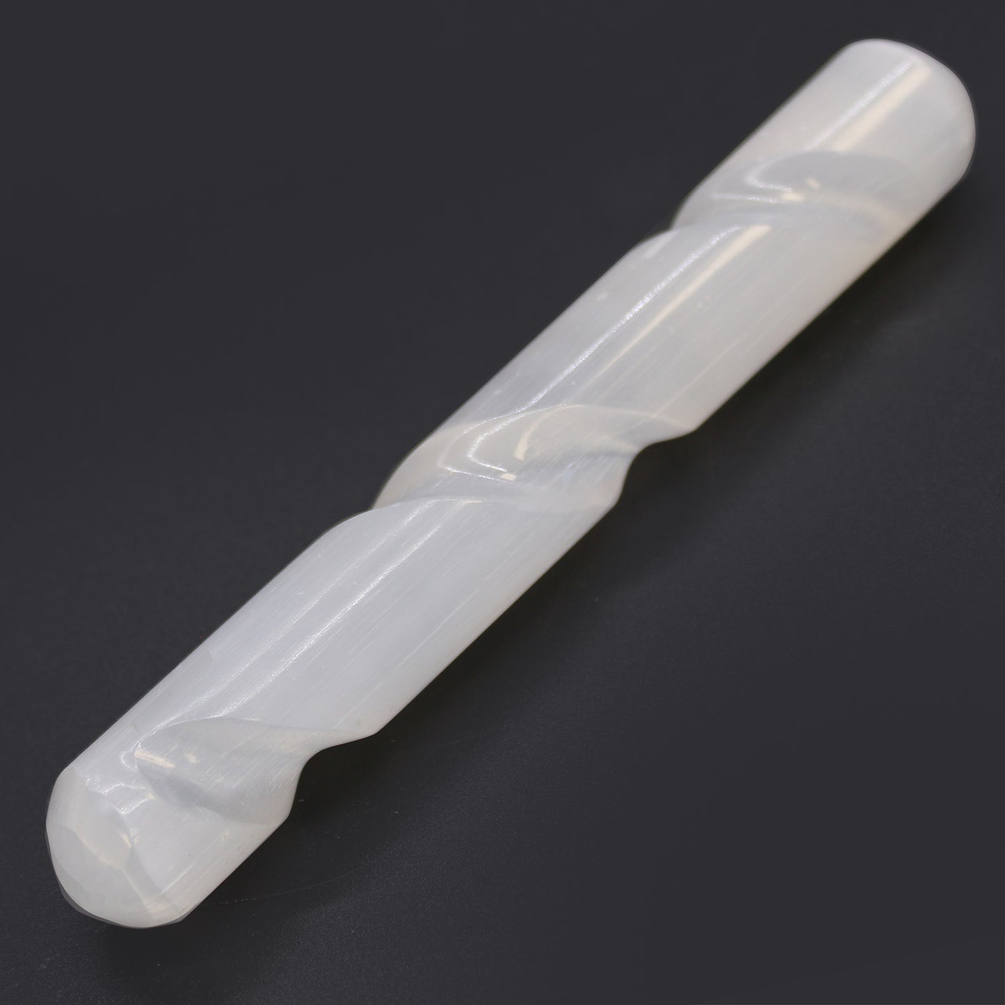 Carved Selenite wand with spiral-grooved body and smooth rounded ends, handcrafted from Moroccan crystal for chakra balancing, aura cleansing, and meditation.