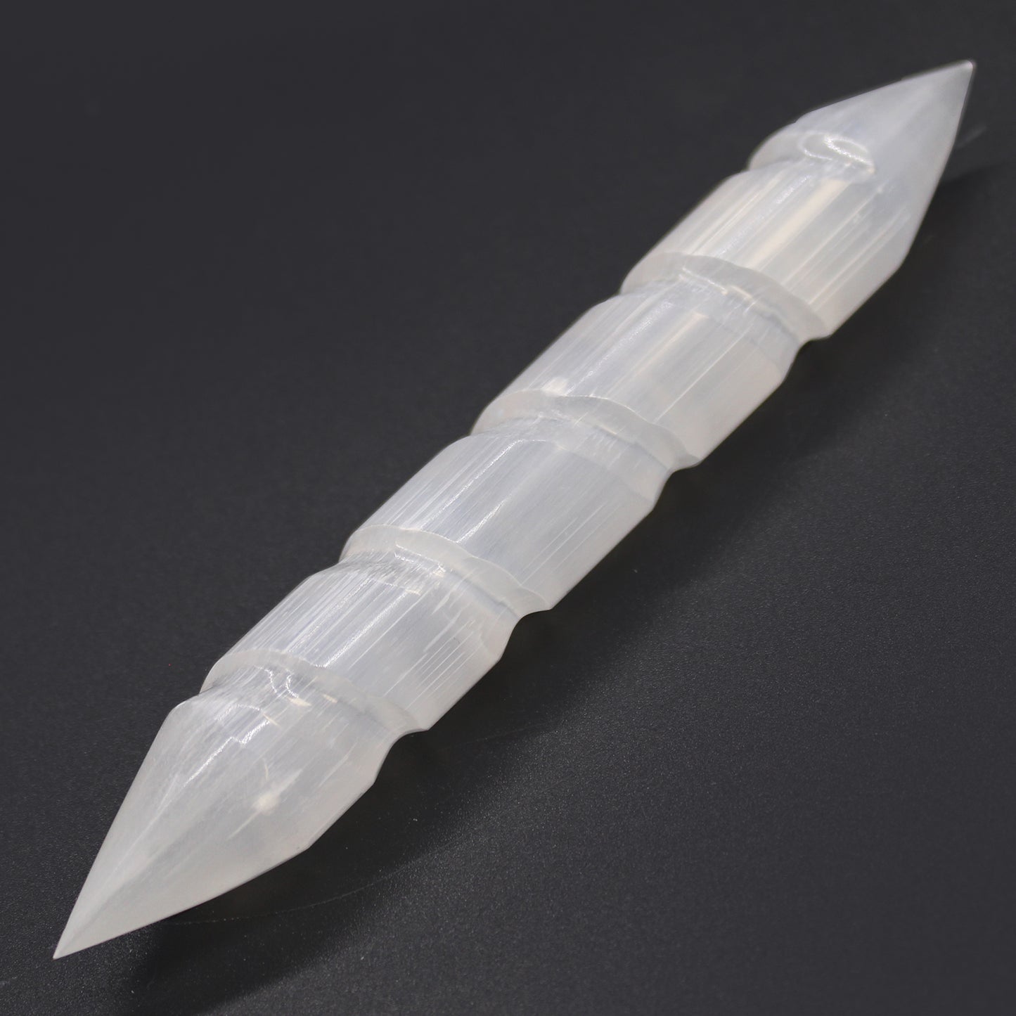 Double-terminated carved Selenite wand with grooved body, hand-cut from Moroccan crystal. Ideal for chakra healing, reiki, and spiritual energy cleansing.