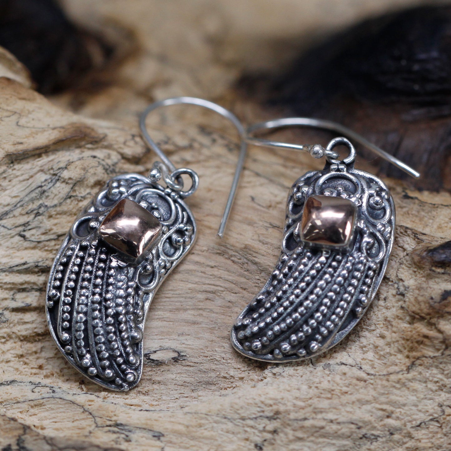 "Angel wing earrings made of 925 silver with detailed beading and 18k gold accent, handcrafted in Indonesia."