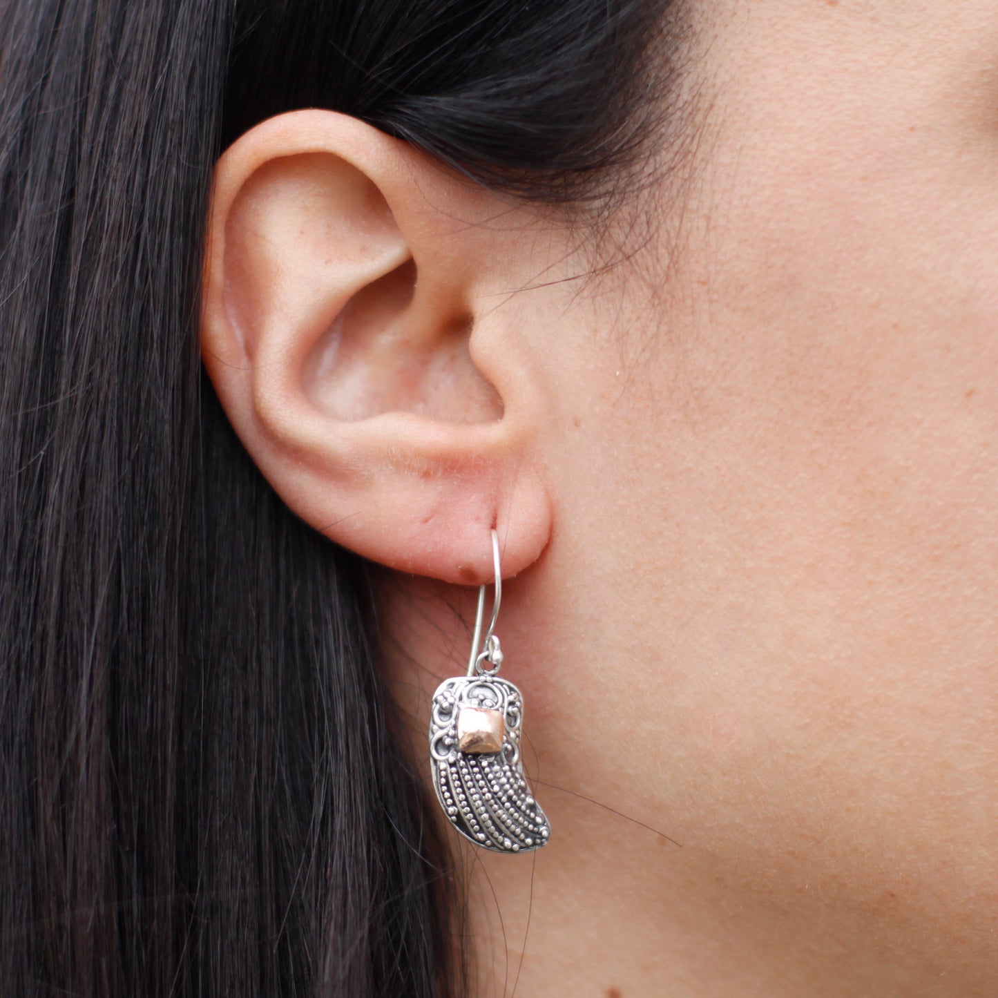 "Angel wing earrings made of 925 silver with detailed beading and 18k gold accent, handcrafted in Indonesia."