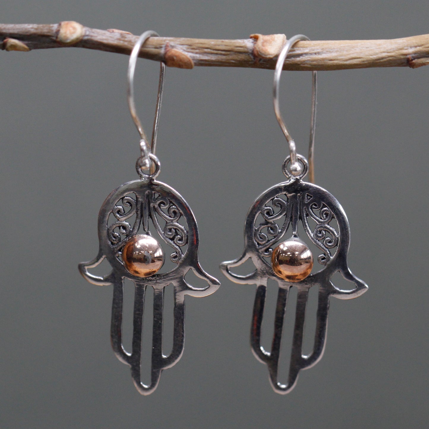 "Hamsa hand earrings in sterling silver with filigree detail and central 18k gold accent, handcrafted in Indonesia."