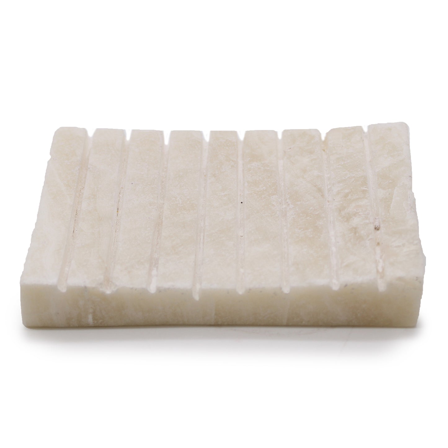 Hand-carved white onyx soap dish with ridged top surface, minimalist and elegant.