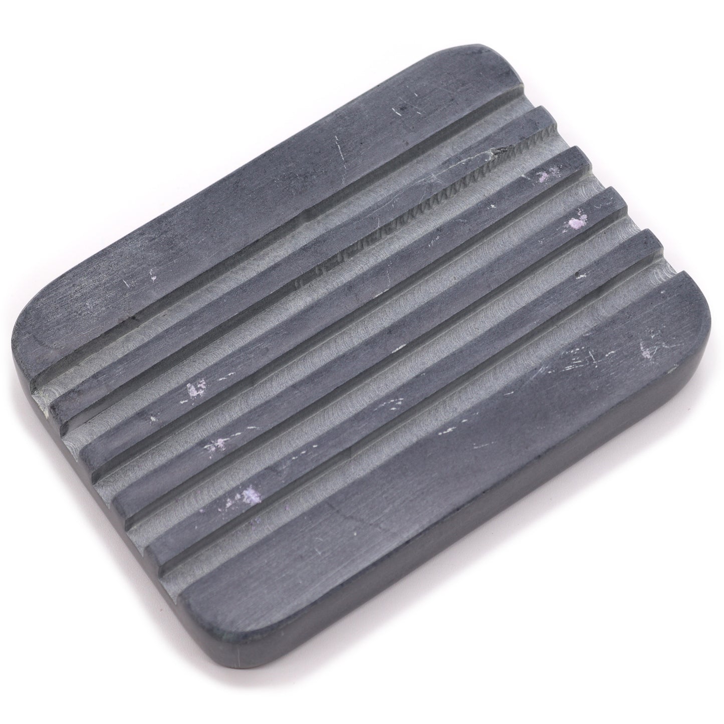 Rectangular grey soapstone soap dish with drainage grooves.