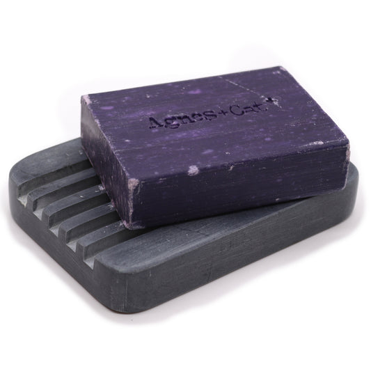 Rectangular grey soapstone soap dish with drainage grooves.