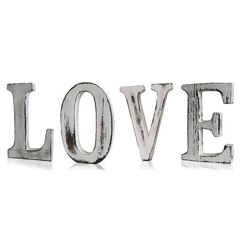 Whitewashed wooden letters spelling "LOVE", handcrafted in a rustic shabby chic style from sustainable mango wood
