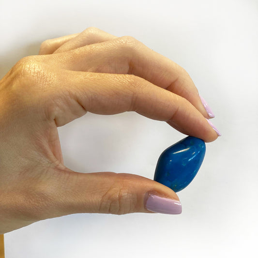 Polished Blue Howlite tumbled stones (10–25 mm), calming blue with marbled veining, symbolising peaceful communication and emotional clarity.