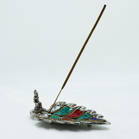Handcrafted Tibetan incense holder with Buddha figurine and colourful mosaic in a feathered leaf design for spiritual home décor.