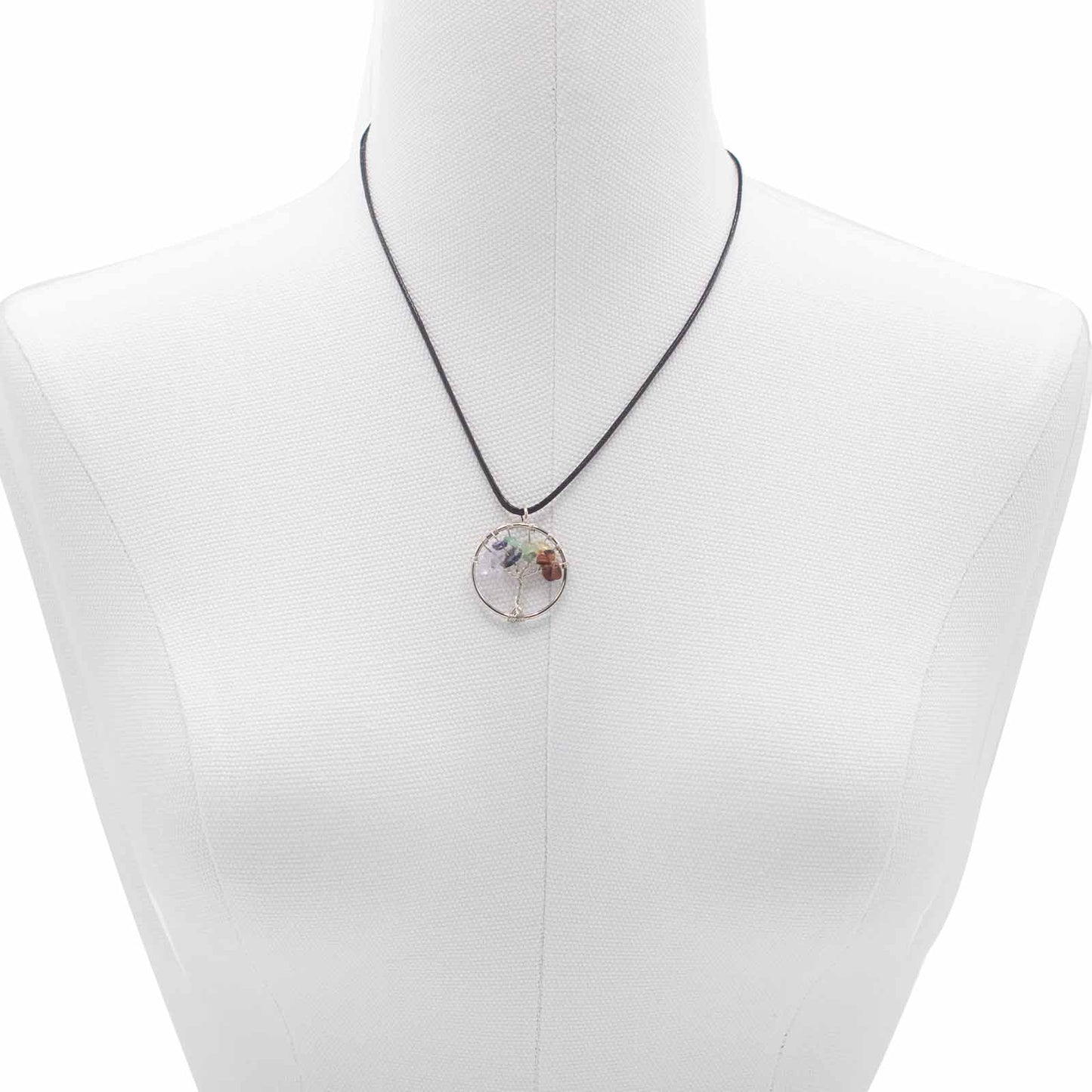 "Tree of Life Pendant featuring seven Chakra gemstones arranged in a rainbow design, crafted with silver wire on a black cord."