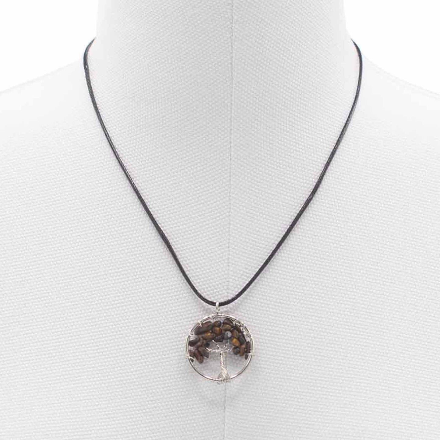 "Tree of Life Pendant featuring a golden-brown Tiger’s Eye gemstone, delicately wire-wrapped in silver, hanging on a black cord necklace."