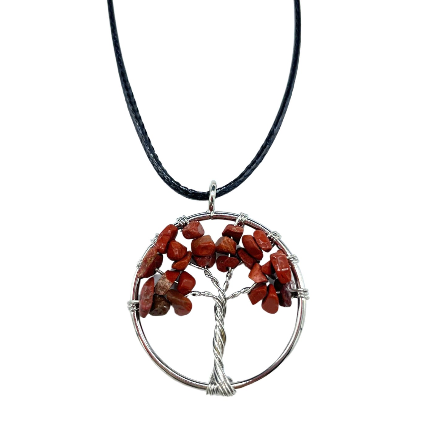"Tree of Life Pendant featuring a deep red Jasper gemstone in a delicately wire-wrapped silver design, suspended on a black cord."