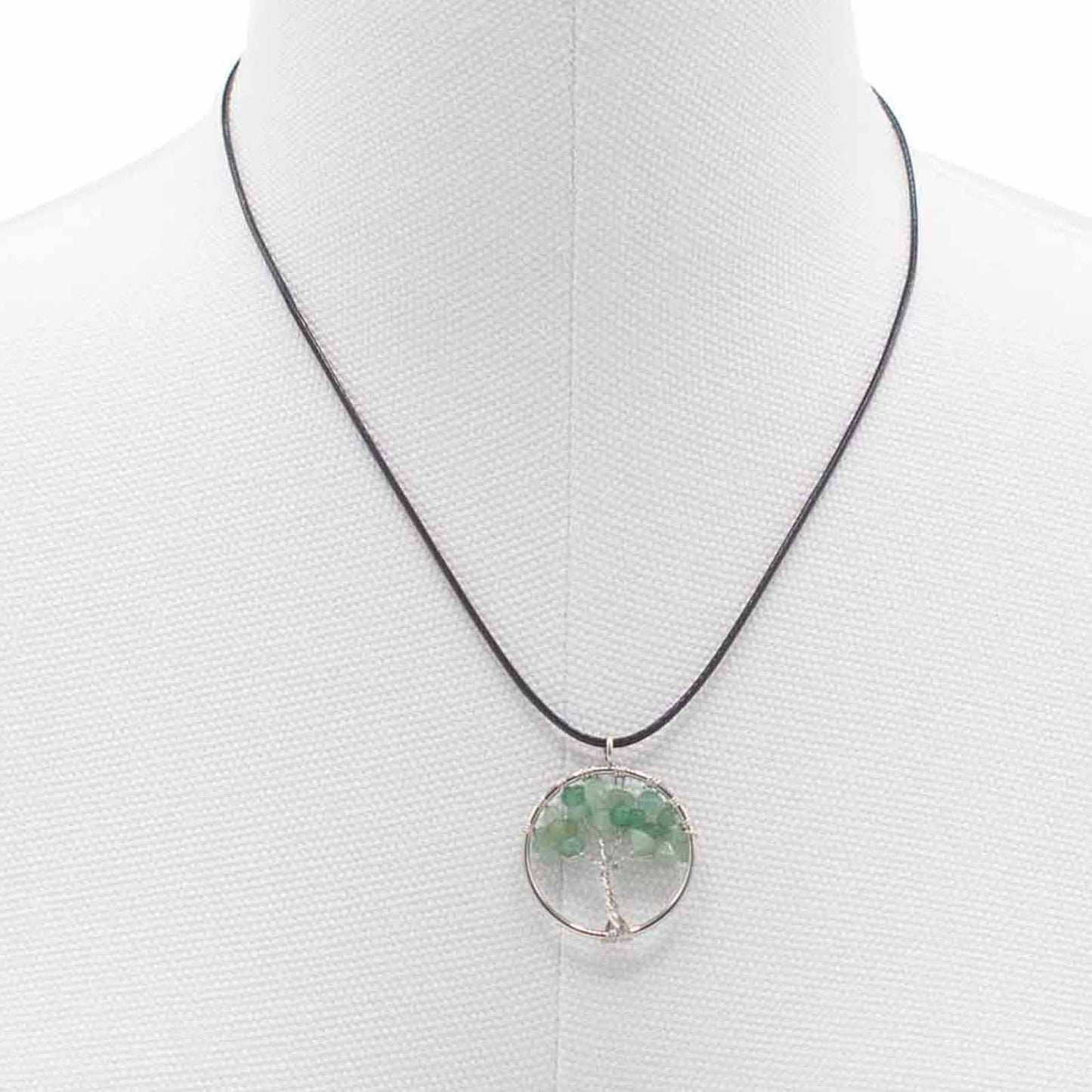 "Tree of Life Pendant with soothing green Jade gemstone and silver wire-wrapped design, hanging on a black cord."