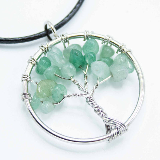 "Tree of Life Pendant with soothing green Jade gemstone and silver wire-wrapped design, hanging on a black cord."