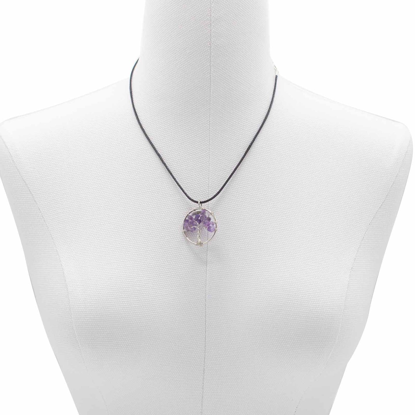 "Tree of Life Pendant featuring a natural Amethyst gemstone in a silver wire-wrapped design, suspended on a black cord."