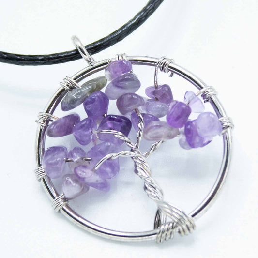 "Tree of Life Pendant featuring a natural Amethyst gemstone in a silver wire-wrapped design, suspended on a black cord."