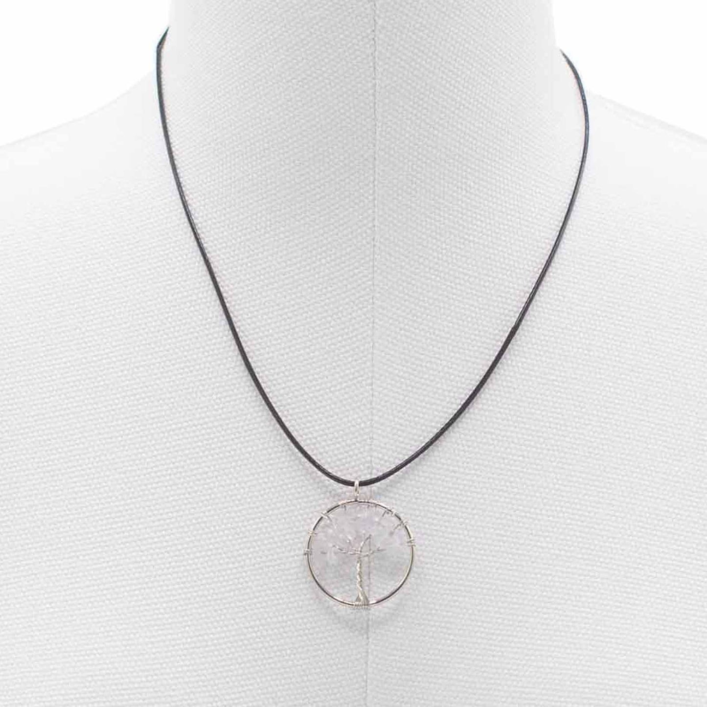 "Tree of Life Pendant with clear Rock Crystal gemstone, silver wire-wrapped design on a black cord necklace."