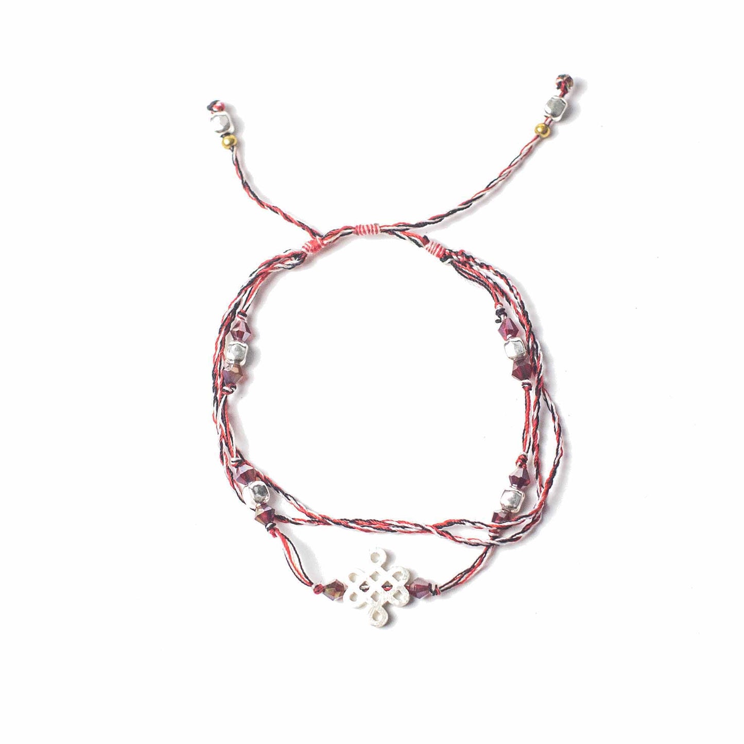 Tri Datu Temple String Bracelet with silver Endless Knot charm symbolizing the journey of life and spiritual perspective.
