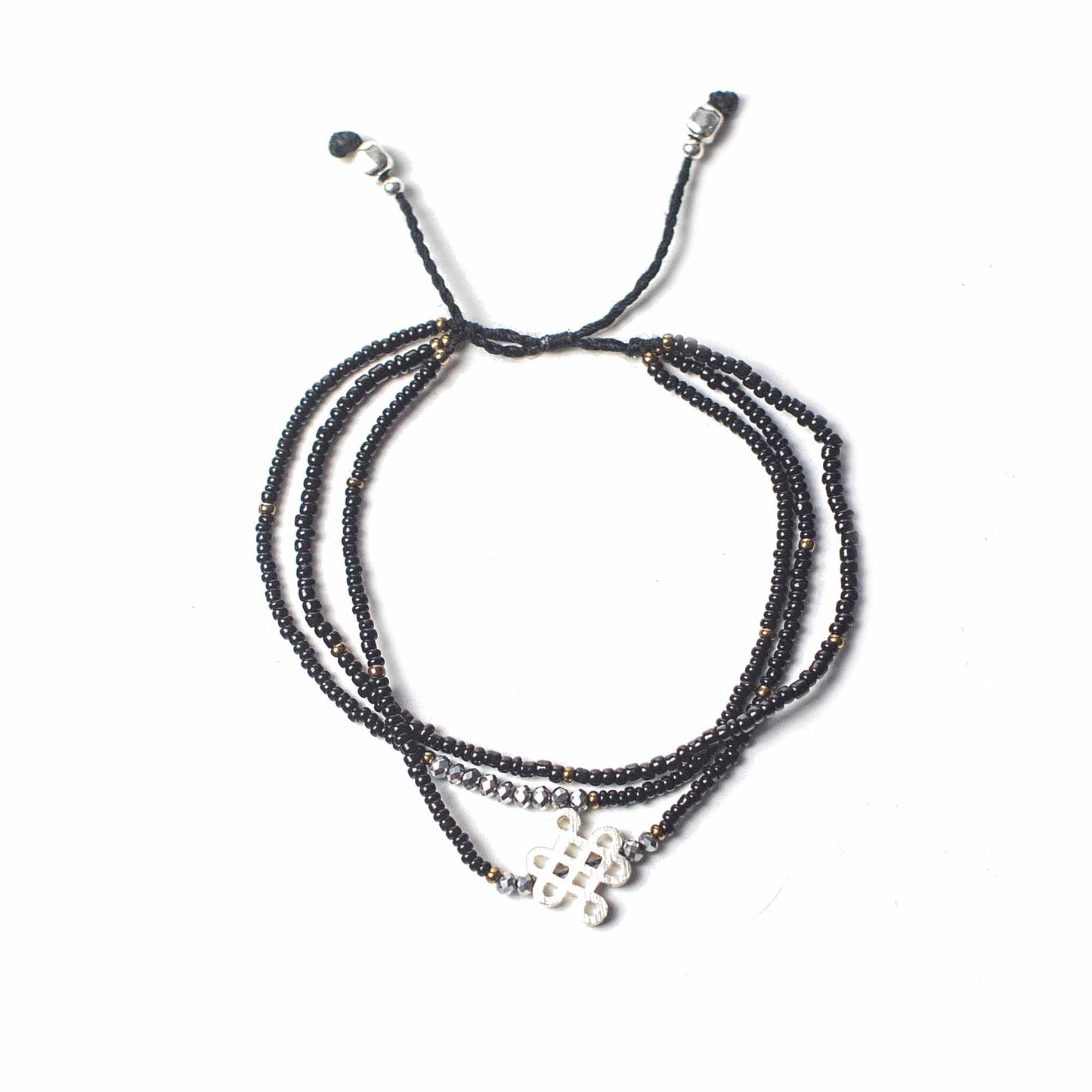 Black Temple String Bracelet with silver Endless Knot charm, symbolizing grounding, balance, and determination.