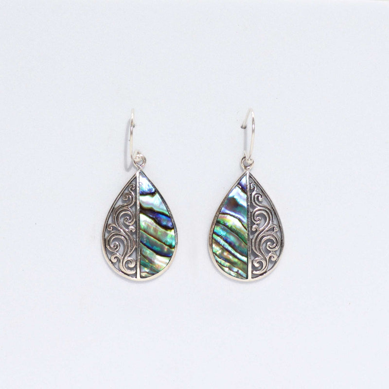 "Teardrop earrings with vertically split design: half abalone shell, half ornate silver swirl pattern, handcrafted in Bali."