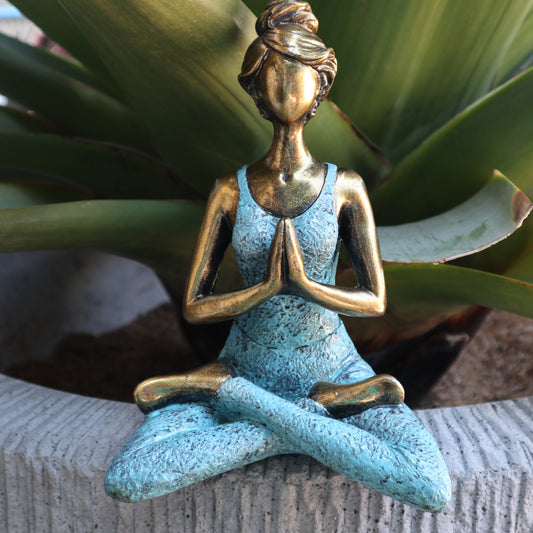 Hand-painted Yoga Lady statue in gold and turquoise, seated in lotus pose with namaste hands
