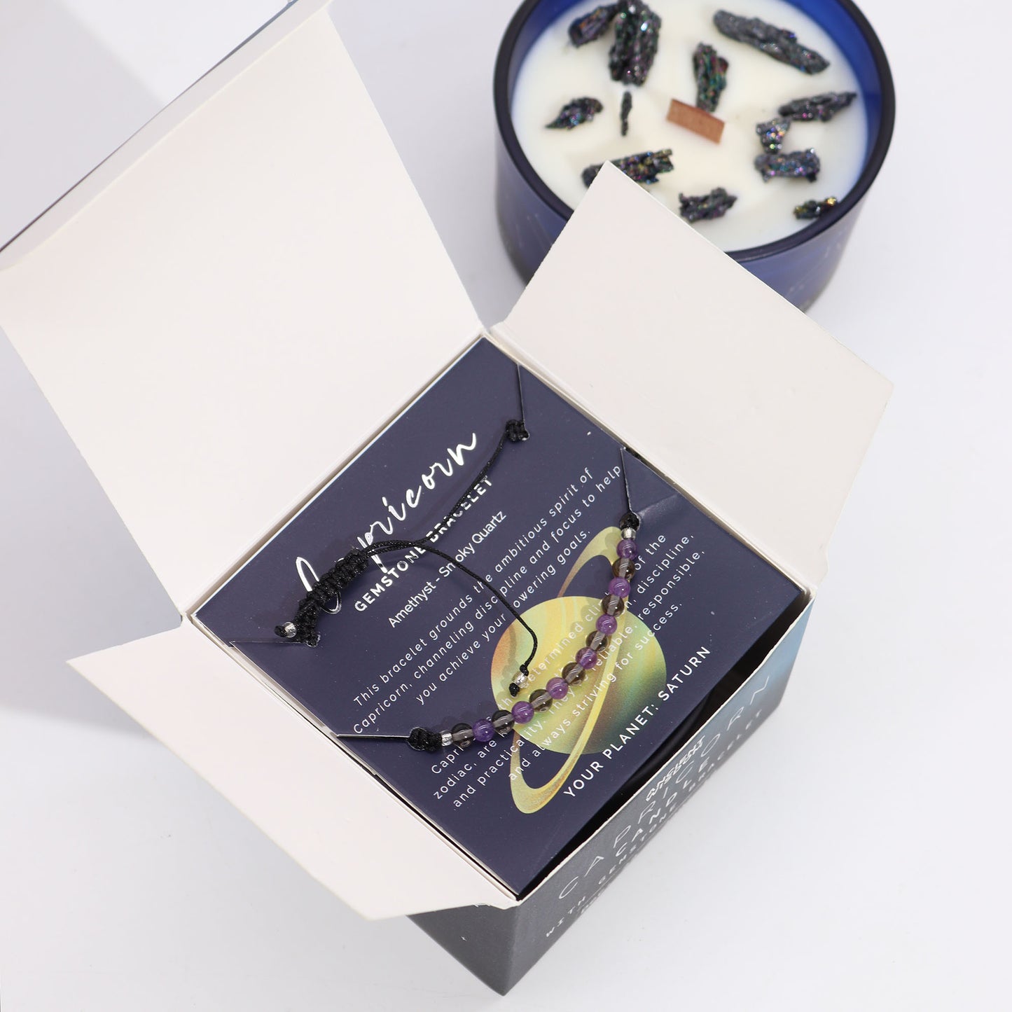 Capricorn Zodiac Crystal Candle with gemstone bracelet, midnight blue jar with constellation and grounding crystal energy