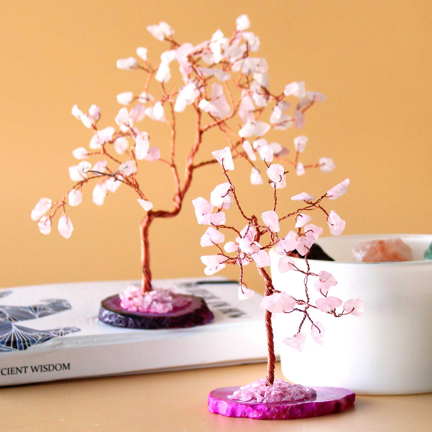Crystal trees made from copper wire with rose quarts crystal chip stones on a pink agate base