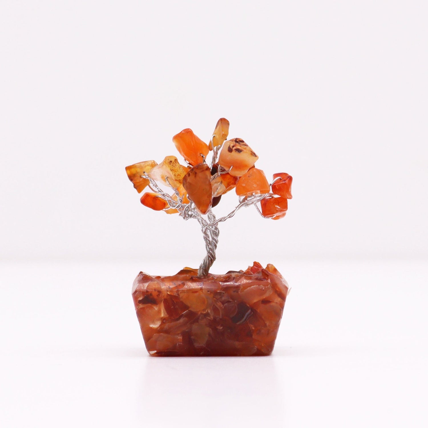 Mini crystal tree made from metal wire and Carnelian crystal chip stones on an orgonite base