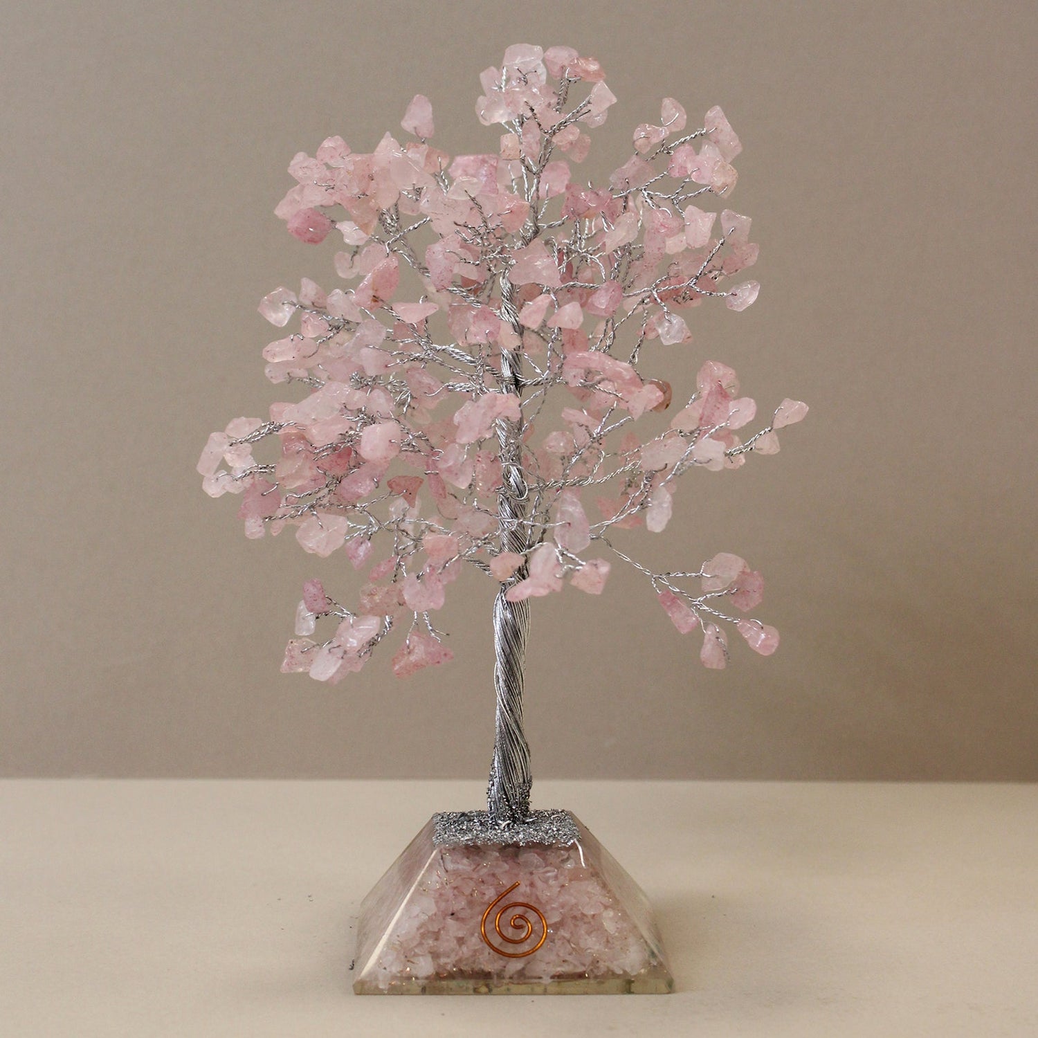 Crystal tree made from metal wire with rose quarts crystal chip stones on an orgonite base