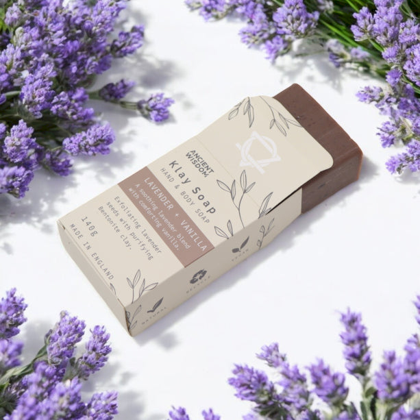 Bar of soap in cardboard box on white background surrounded by lavender flowers, clay soap for hands and body, Lavender and Vanilla scented, 140g, no SLS, No parabens, vegan friendly 