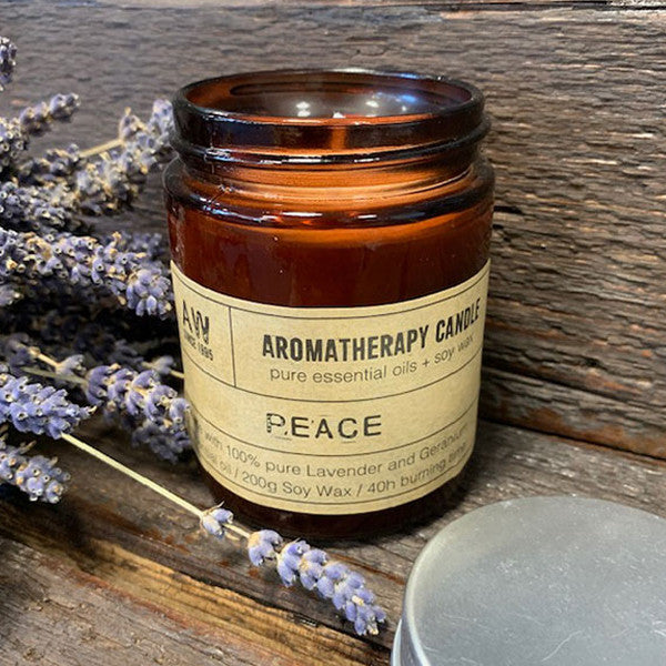 Peace soy wax aromatherapy candle with lavender and geranium essential oils in amber jar
