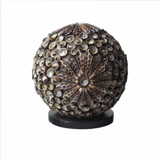 Chocolate-toned seashell globe lamp with floral twist pattern – handcrafted in Indonesia, 15cm diameter, boho coastal lighting.

