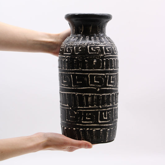 Tall black terracotta vase with straight form and carved Greek pattern – handcrafted in Lombok, ideal for dried floral arrangements.

