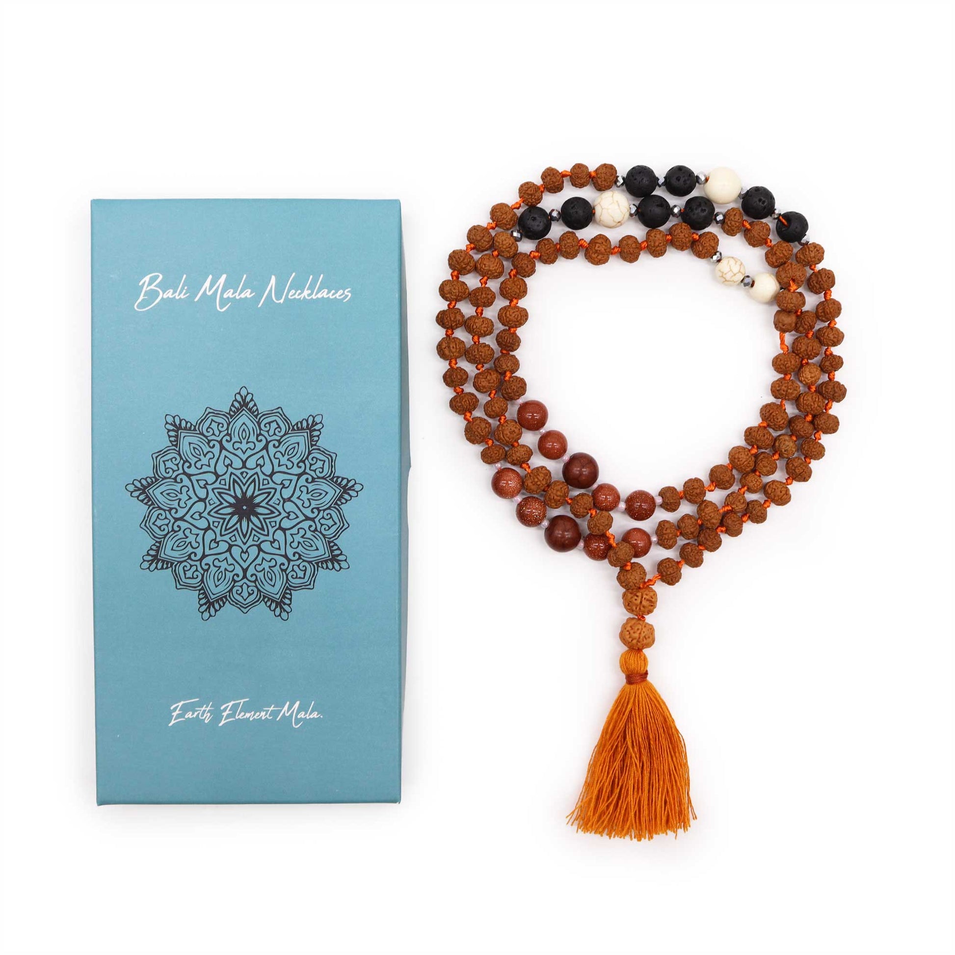 "Earth Element Mala necklace with Rudraksha, volcanic stones, warm red and cream-toned accents, and ochre tassel, shown with gift box."