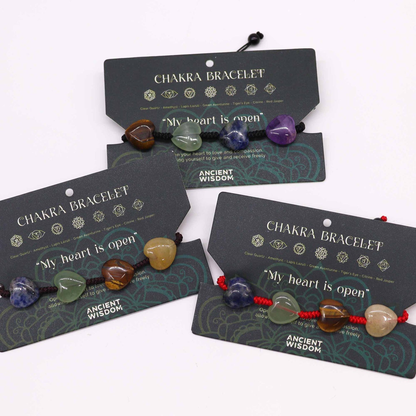 Chakra string bracelet with gemstone beads and “My heart is open” affirmation on adjustable cotton cord.

