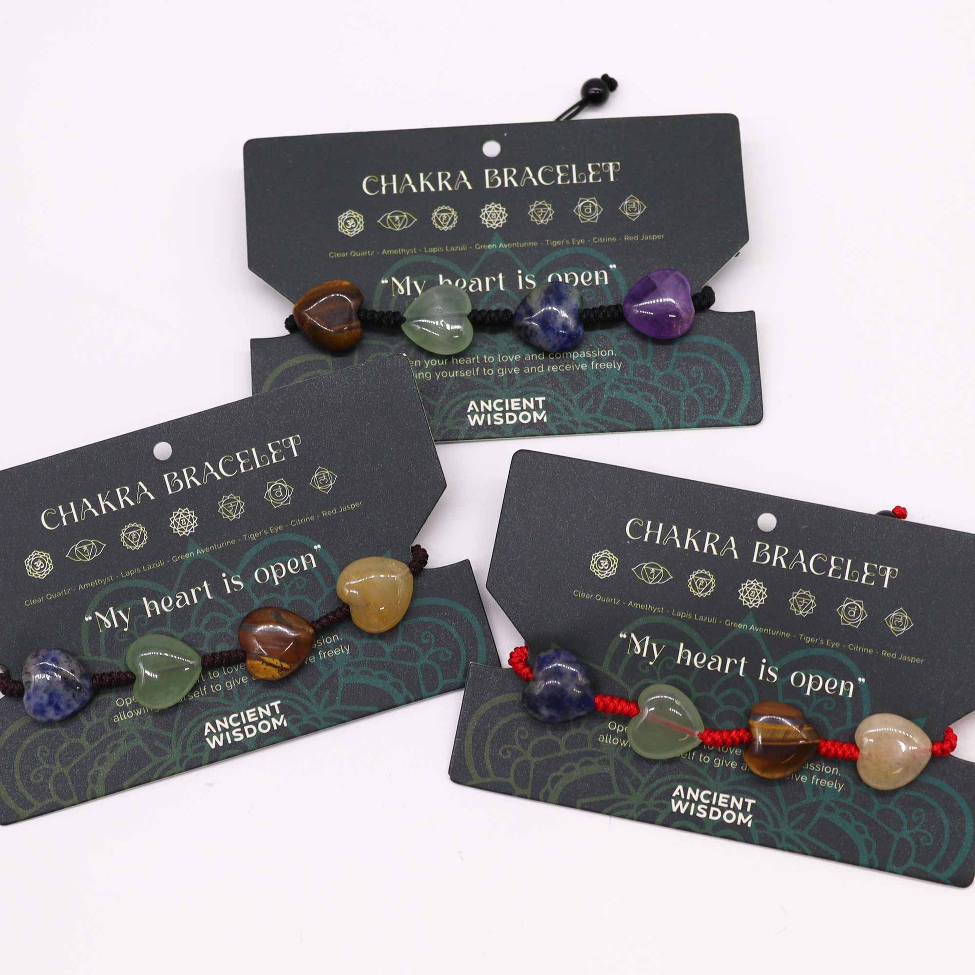 Chakra string bracelet with gemstone beads and “My heart is open” affirmation on adjustable cotton cord.


