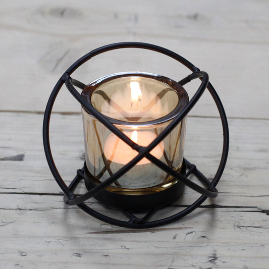 Orb-shaped iron candle holder with amber glass votive – single tealight design