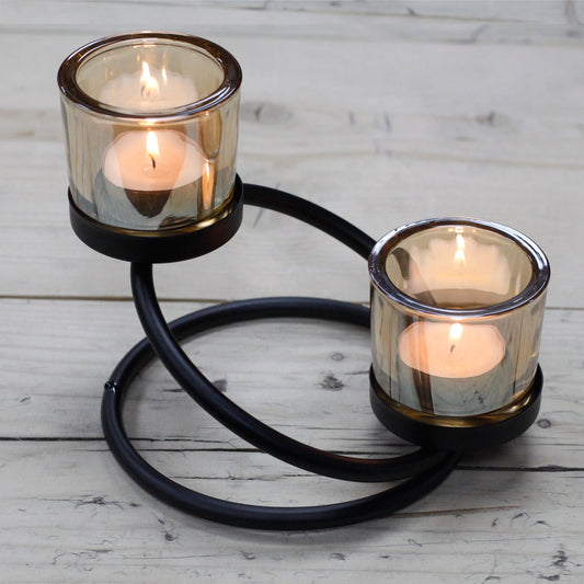 Double iron votive candle holder with circular swirl base and amber glass – decorative lighting piece