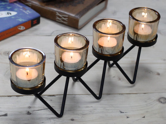 Quadruple iron votive candle holder with zigzag base and amber glass – modern decorative centrepiece