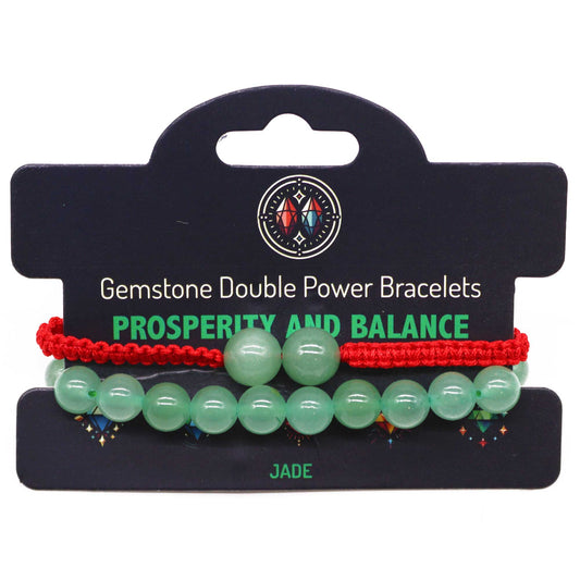 Jade gemstone bracelet with two large beads and “Prosperity and balance” affirmation on adjustable elastic cord.

