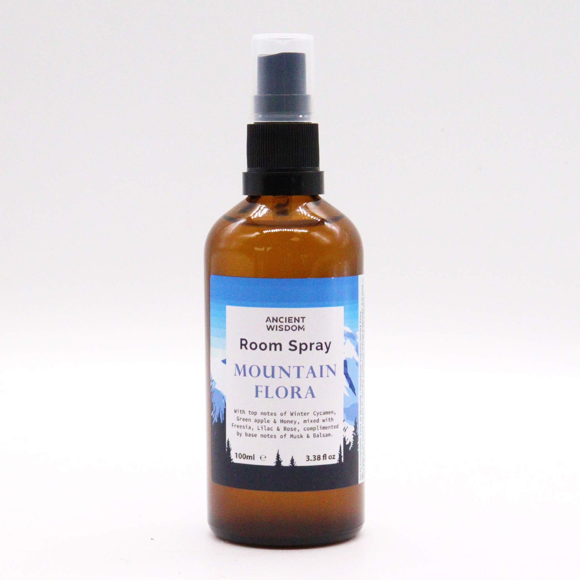 Amber glass bottle of Mountain Flora room spray – 100ml, featuring floral, green, and musky fragrance notes.

