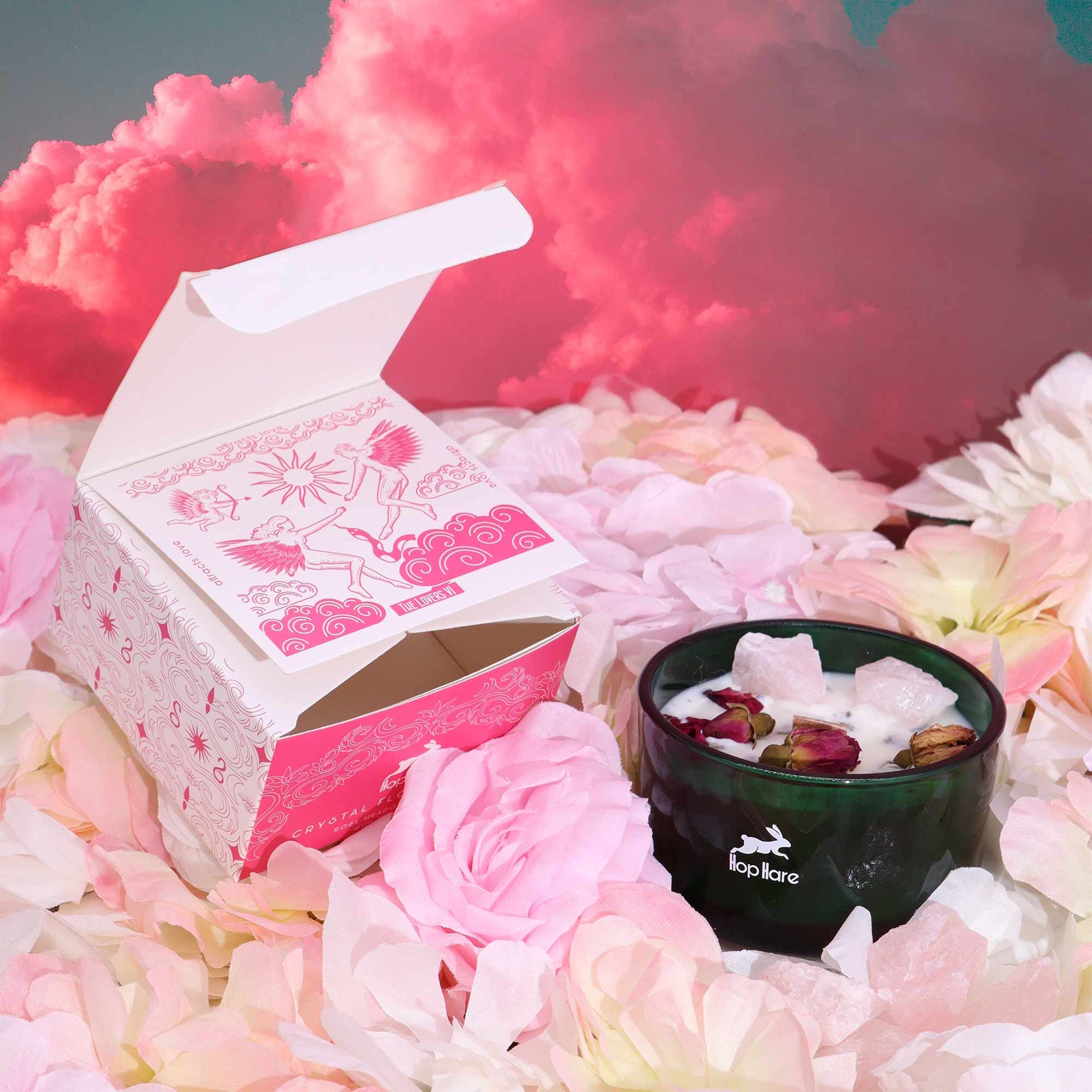 Hop Hare The Lovers crystal candle with rose quartz, rose petals, and tarot card in dark green jar
