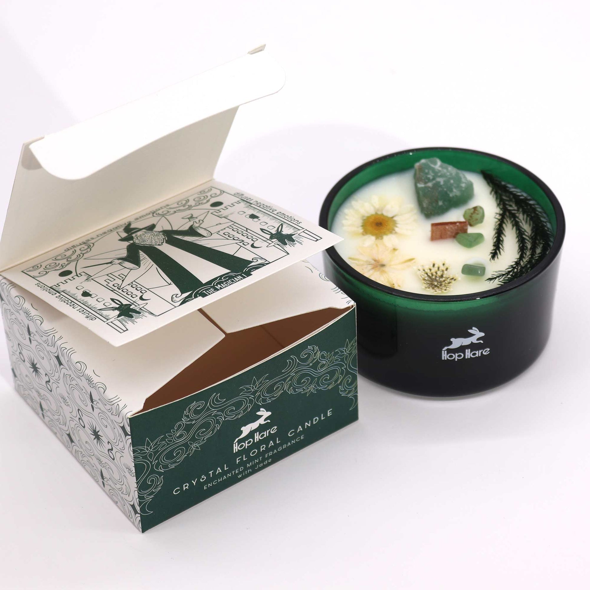 Hop Hare The Magician crystal candle with jade, dried flowers, and tarot card in dark green jar

