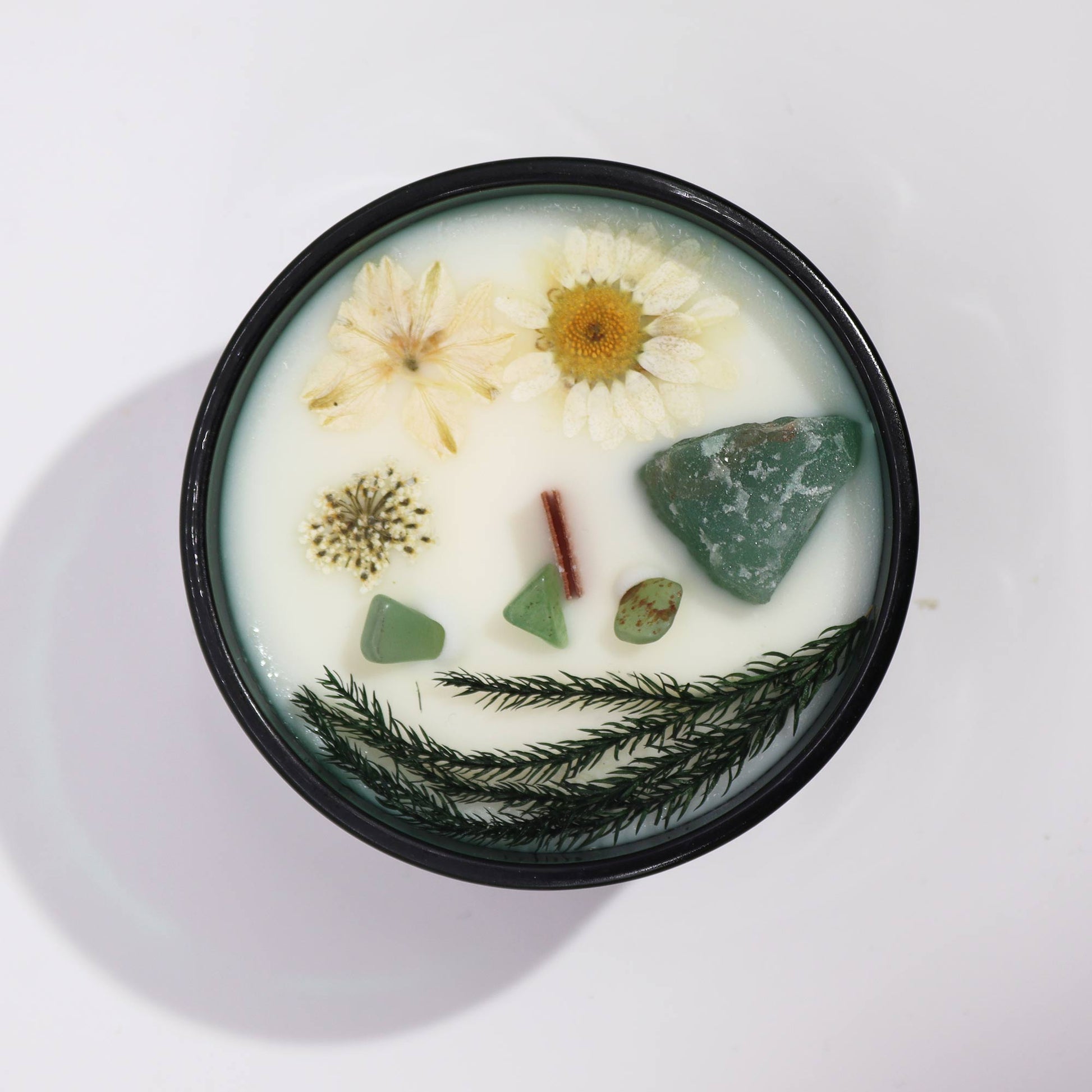 Hop Hare The Magician crystal candle with jade, dried flowers, and tarot card in dark green jar
