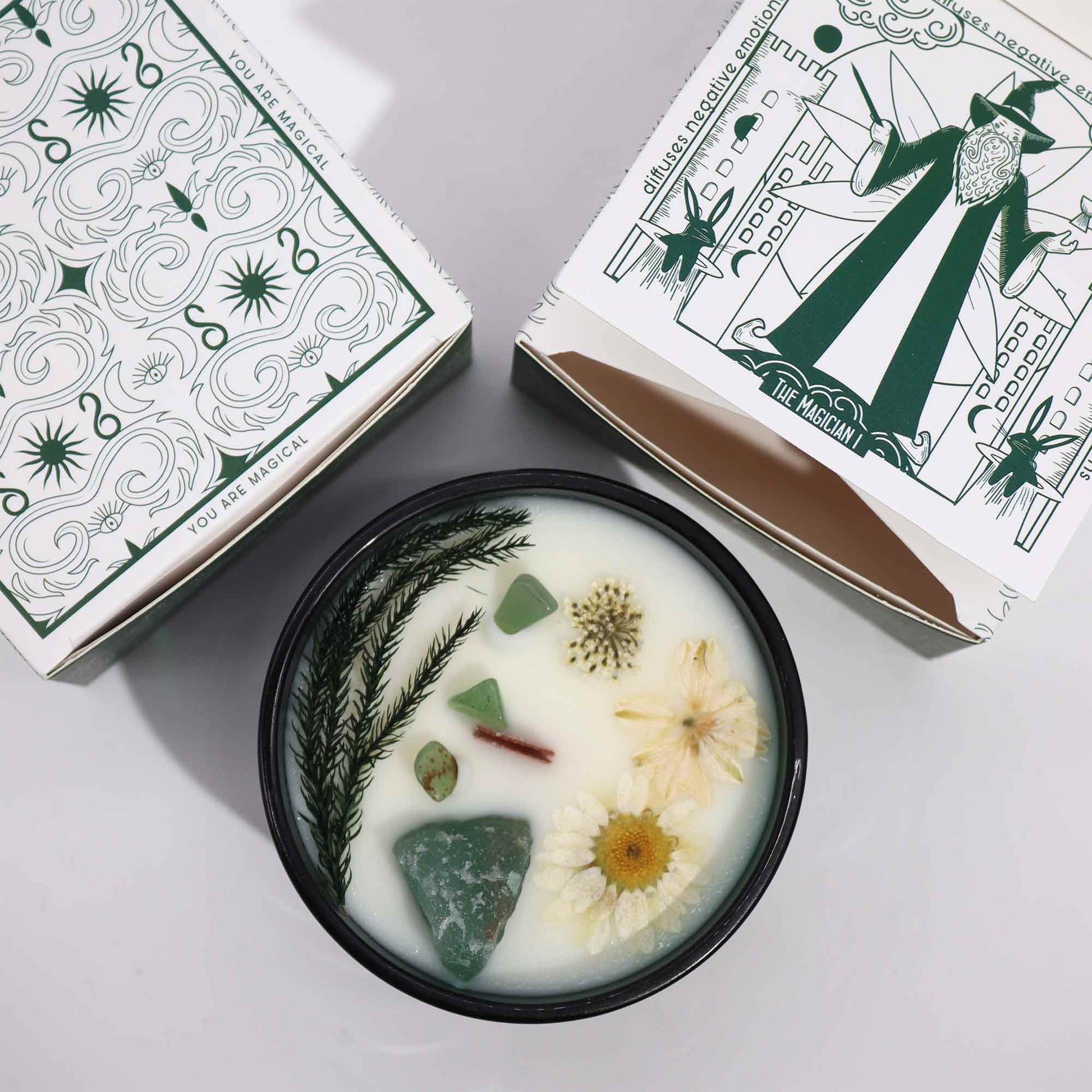 Hop Hare The Magician crystal candle with jade, dried flowers, and tarot card in dark green jar

